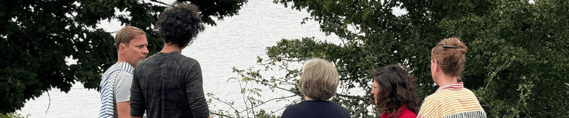 Group of persons standing by a lake